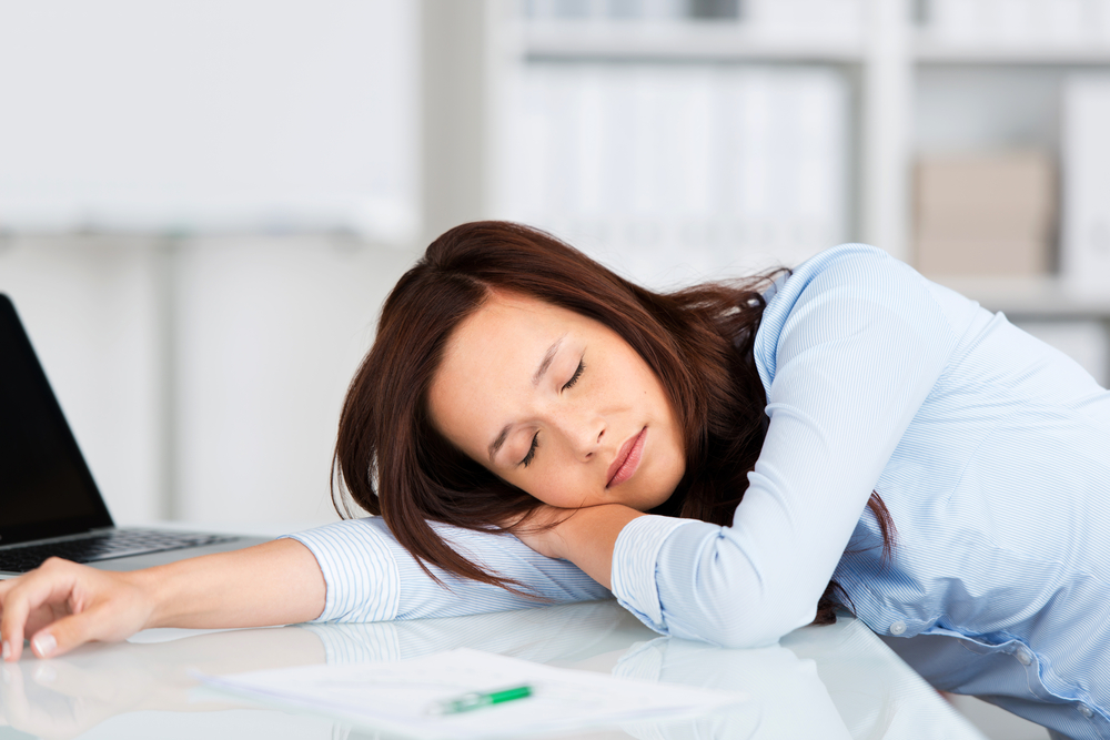 A woman asleep at her desk at work