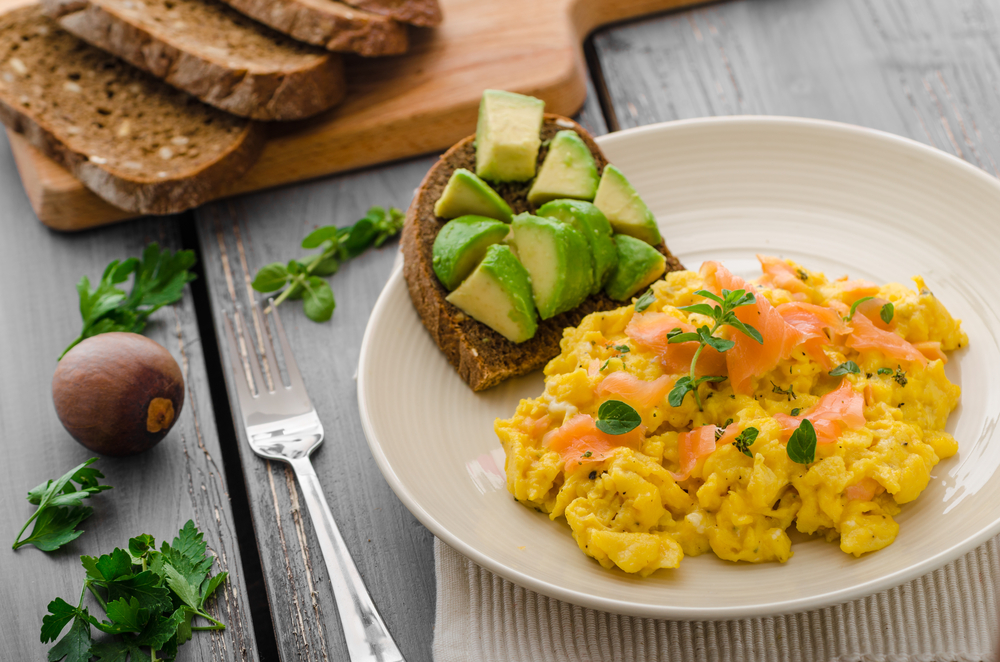 Scrambled eggs on toast with smoked salmon and avocado