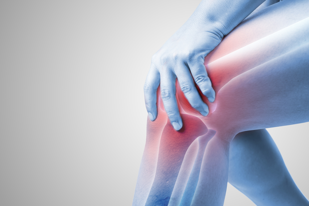 Close up of knee showing the knee joint underneath to represent joint pain
